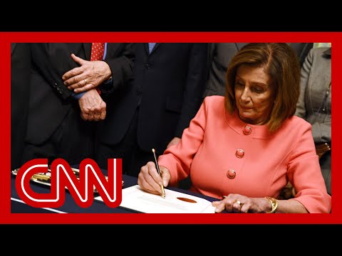 Pelosi signs impeachment articles against President Trump 1