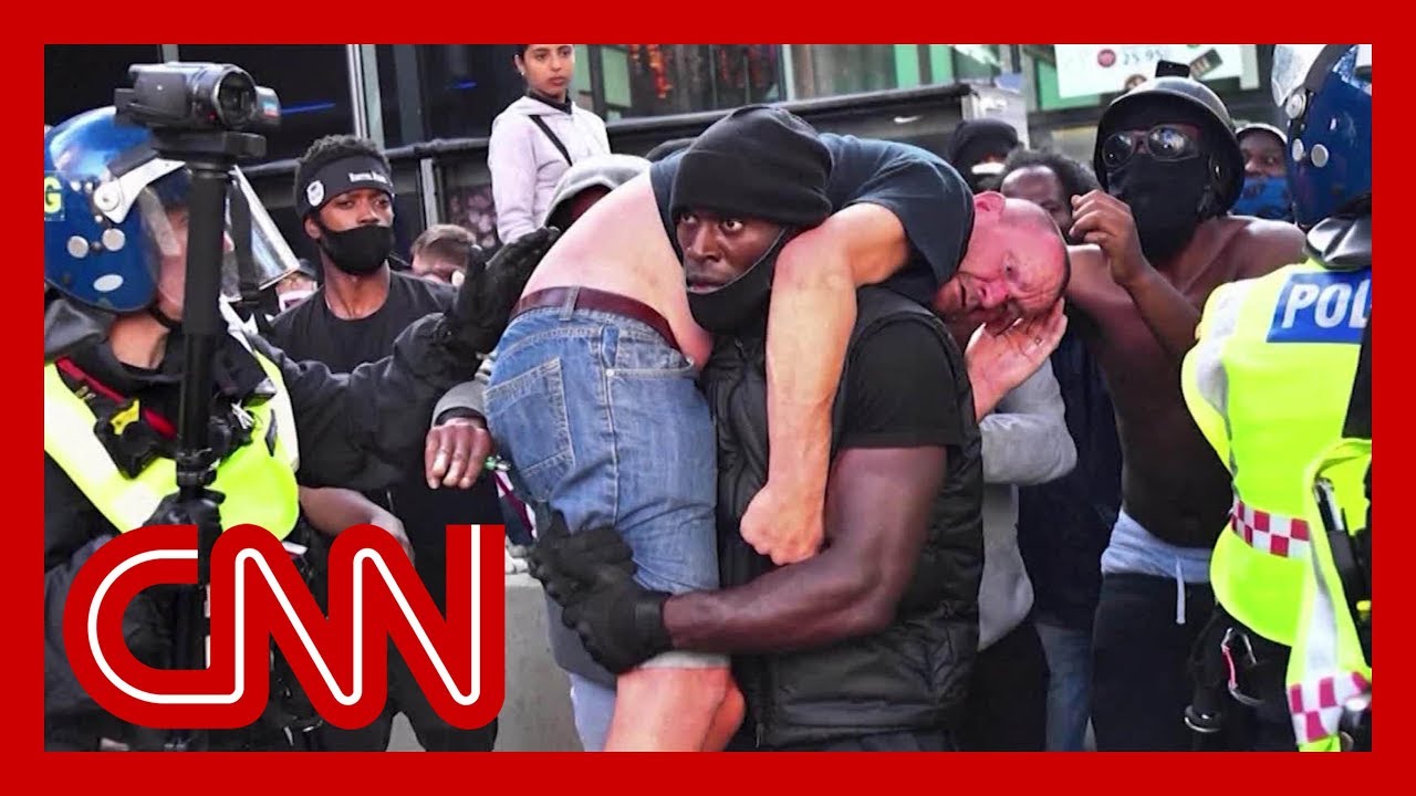 Black Lives Matter demonstrator carries injured white protester to safety in powerful image 1