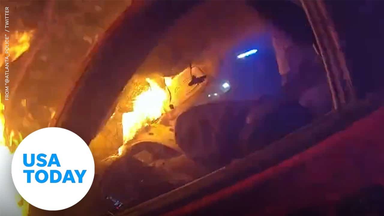 Two Atlanta police officers rescue man from burning car | USA TODAY 1