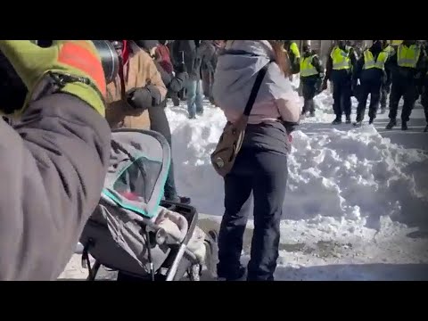 Protester with baby stands in the way of police | Over 100 arrested in Ottawa demonstrations 1