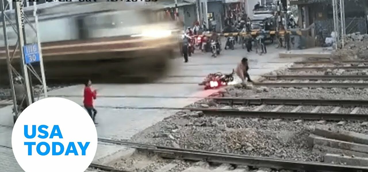 Lucky biker narrowly avoids being hit by train in northern India | USA TODAY 1