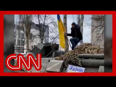 Man jumps on top of moving armored Russian vehicle while waving Ukrainian flag 1