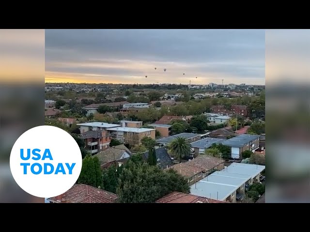 Hot air balloon ride goes sideways, riders nearly touch rooftops | USA TODAY 1