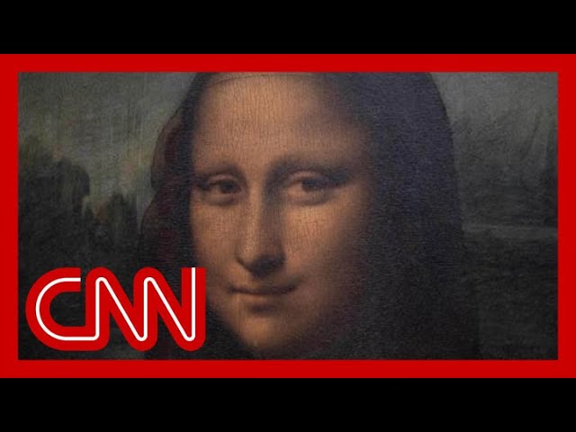 Man in disguise throws a cake at the 'Mona Lisa' 1